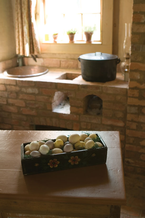 The kitchen hearth includes this potager, what the French call a masonry stove fitted with small chambers that hold charcoal for simmering pots.